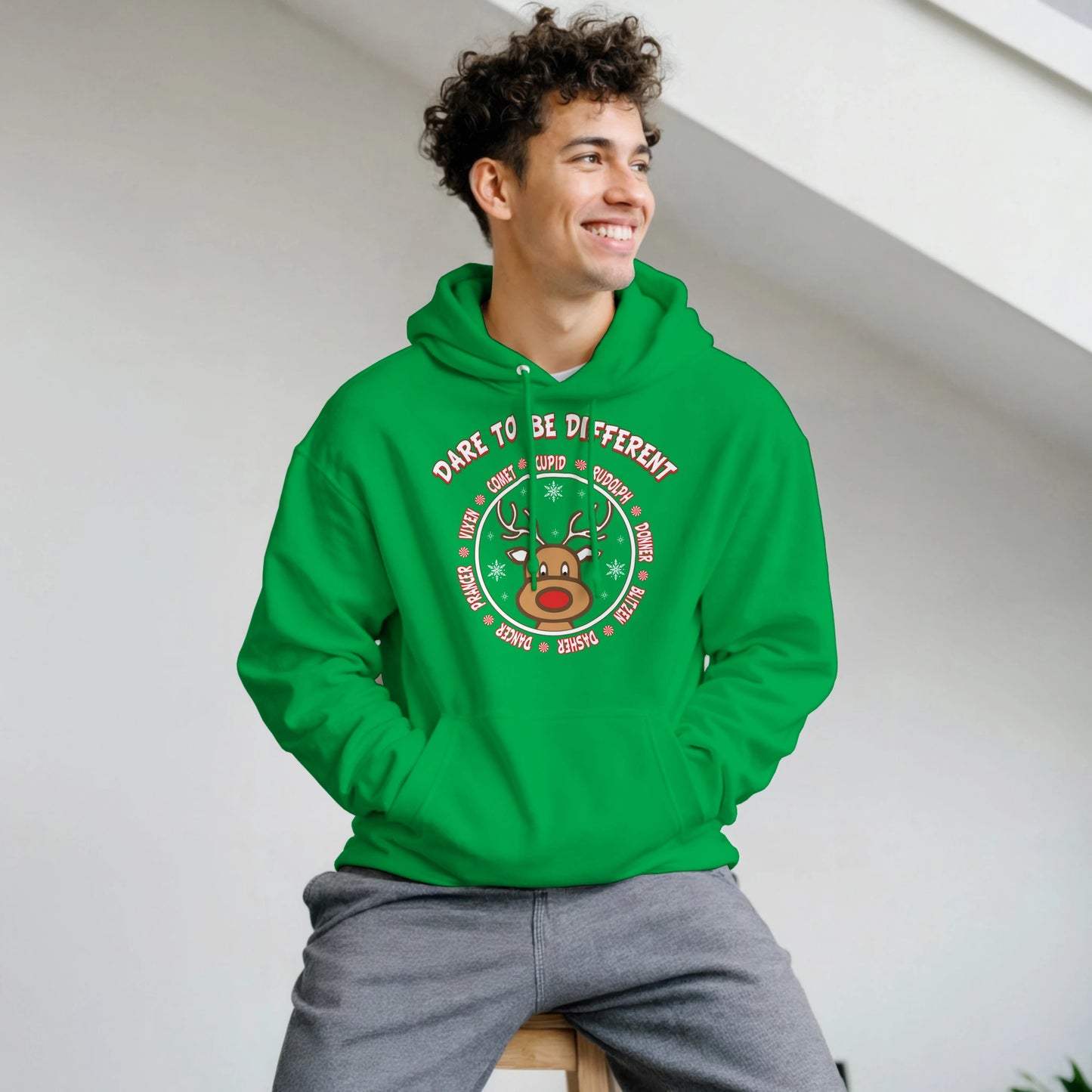 Stand out with Rudolph Hoodie
Man wearing green hoodie with front design pic of Rudolph and the Reindeer names surrounding him. with Dare to be different on it. 