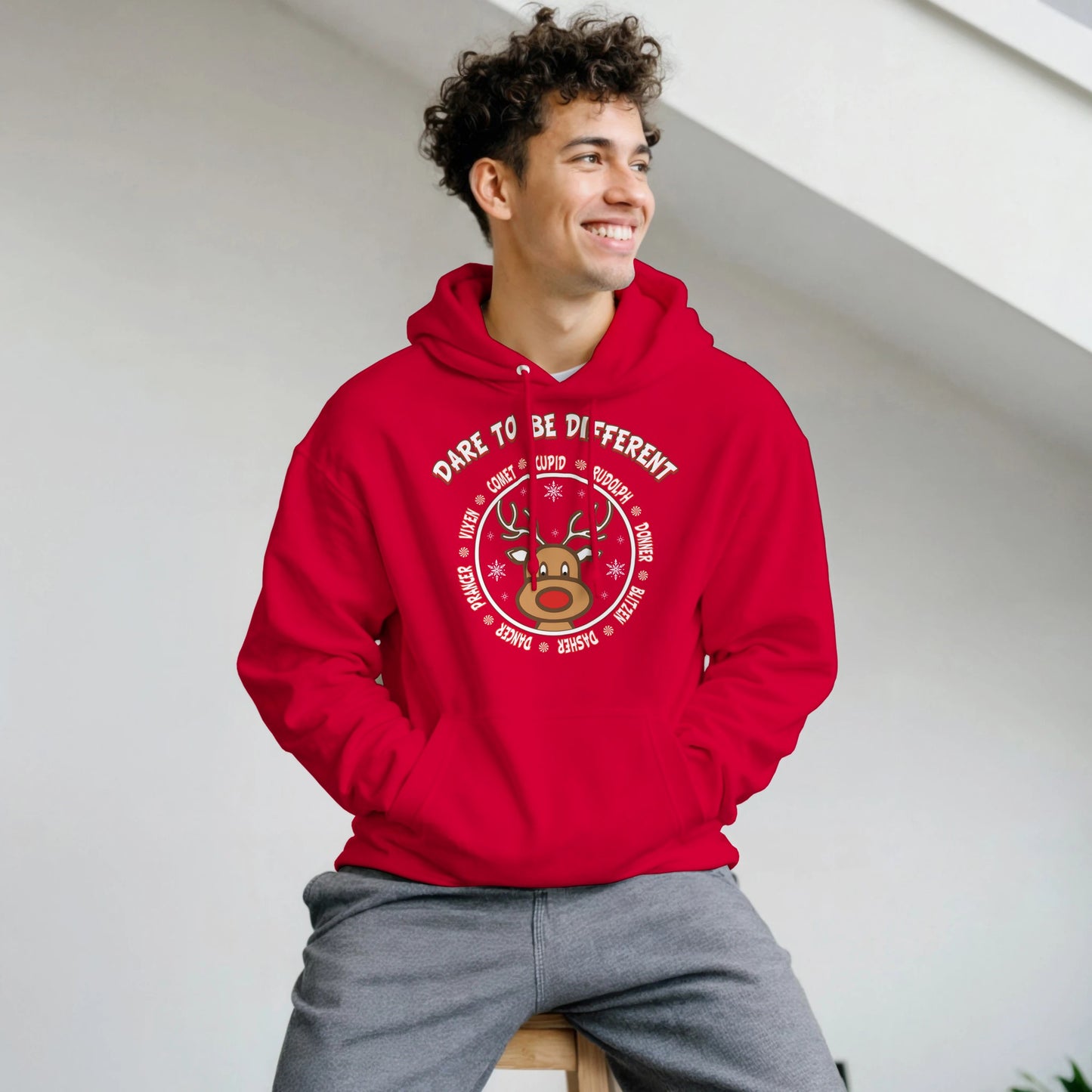 Stand out with Rudolph Hoodie
Man wearing red hoodie with front design pic of Rudolph and the Reindeer names surrounding him. with Dare to be different on it. 